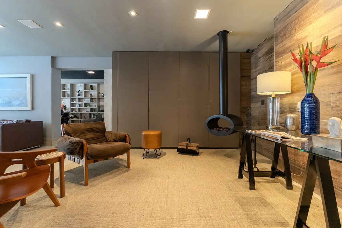 Lobby fireplace, with armchairs and a wood-paneled wall