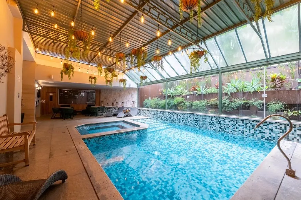 Indoor heated pool, with a hot tub and glass roof